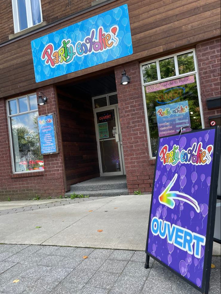 Brick building with 'Party en Folie' sign and purple sign out front.